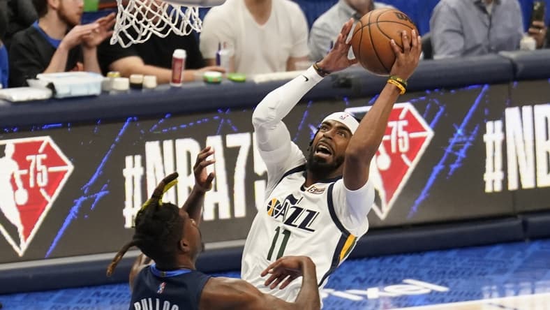 Apr 16, 2022; Dallas, Texas, USA; Utah Jazz guard Mike Conley (11) shoots over Dallas Mavericks forward Reggie Bullock (25) in the first half of game one of the first round for the 2022 NBA playoffs at American Airlines Center. Mandatory Credit: Scott Wachter-USA TODAY Sports