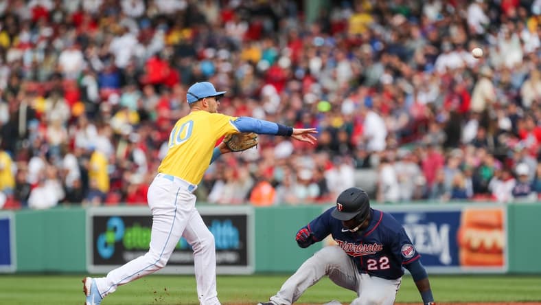 Apr 16, 2022; Boston, Massachusetts, USA; Boston Red Sox second baseman Trevor Story (10) throws over Minnesota Twins first baseman Miguel Sano (22) during the third inning at Fenway Park. Mandatory Credit: Paul Rutherford-USA TODAY Sports