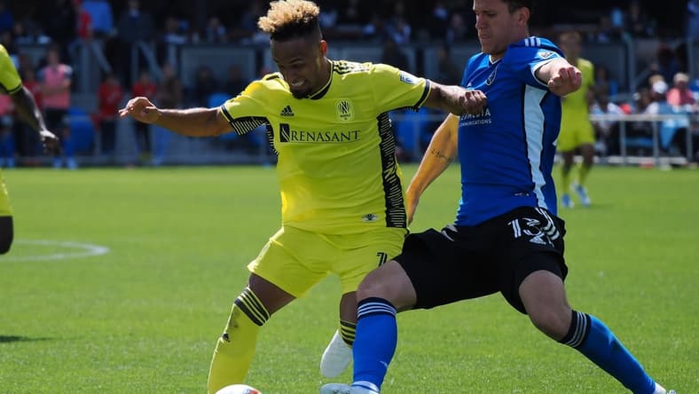 Apr 16, 2022; San Jose, California, USA; San Jose Earthquakes defender Nathan Raphael Pelae Cardoso (13) slide tackles Nashville SC midfielder Hany Mukhtar (10) during the second half at PayPal Park Stadium. Mandatory Credit: Kelley L Cox-USA TODAY Sports