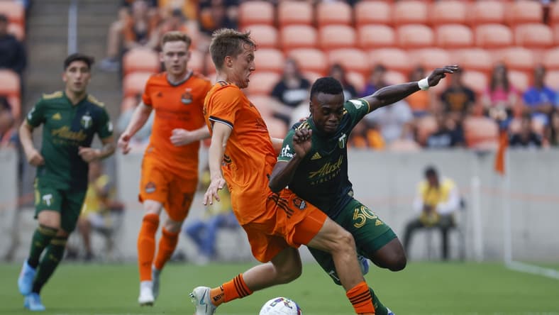 Apr 16, 2022; Houston, Texas, USA; Portland Timbers midfielder Santiago Moreno (30) attempts to get around Houston Dynamo FC midfielder Griffin Dorsey (25) during the first half at PNC Stadium. Mandatory Credit: Troy Taormina-USA TODAY Sports