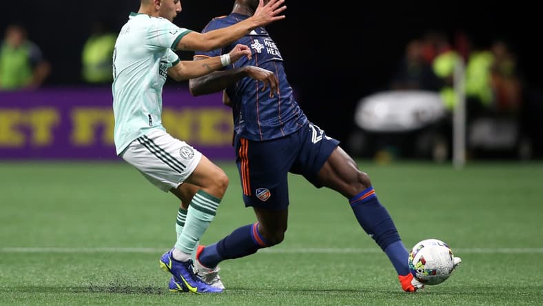Apr 16, 2022; Atlanta, Georgia, USA; Atlanta United midfielder Thiago Almada (8) defends against FC Cincinnati defender Tyler Blackett (24) in the first half at Mercedes-Benz Stadium. Mandatory Credit: Brett Davis-USA TODAY Sports