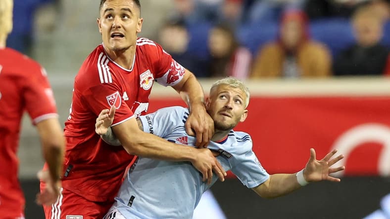 Apr 16, 2022; Harrison, New Jersey, USA; New York Red Bulls midfielder Aaron Long (33) and FC Dallas forward Paul Arriola (7) battle for position in the second half of their game at Red Bull Arena. Mandatory Credit: Vincent Carchietta-USA TODAY Sports