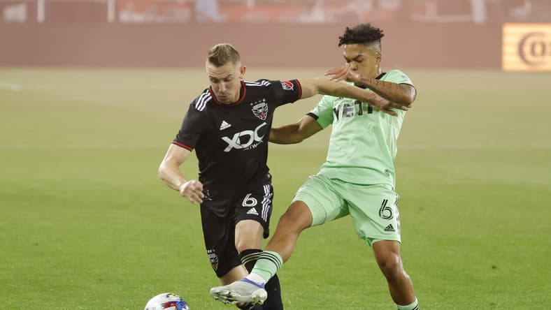 Apr 16, 2022; Washington, District of Columbia, USA; D.C. United midfielder Russell Canouse (6) and Austin FC midfielder Daniel Pereira (6) battle for the ball in the first half at Audi Field. Mandatory Credit: Geoff Burke-USA TODAY Sports