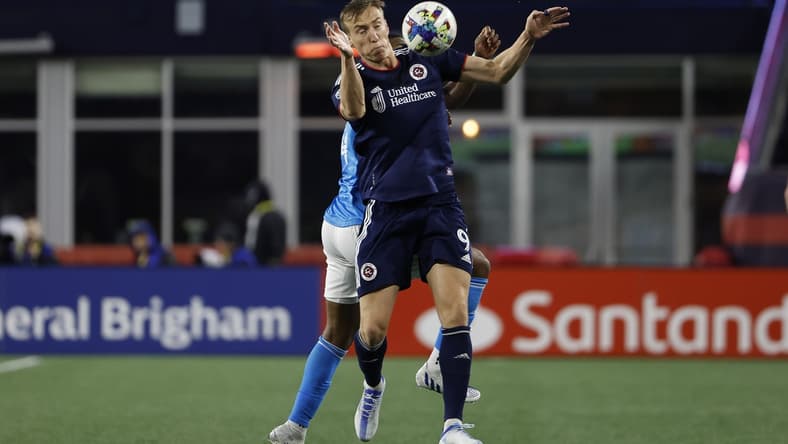 Apr 16, 2022; Foxborough, Massachusetts, USA; New England Revolution forward Adam Buksa (9) tries to control the ball in front of Charlotte FC defender Christian Makoun (14) during the second half at Gillette Stadium. Mandatory Credit: Winslow Townson-USA TODAY Sports