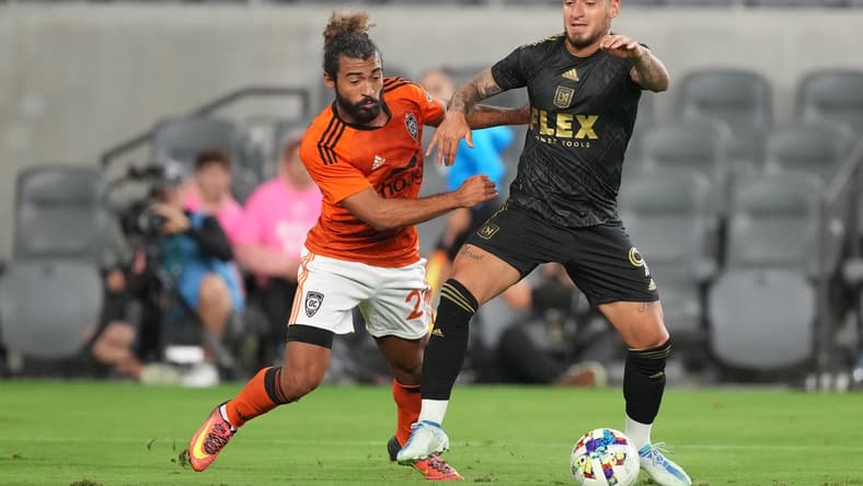 Apr 20, 2022; Los Angeles, California, USA; LAFC forward Cristian Arango (9) and Orange County SC defender Danny Acosta (24) battle for the ball in the second half at Banc of California Stadium. Mandatory Credit: Kirby Lee-USA TODAY Sports