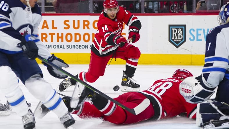 Apr 21, 2022; Raleigh, North Carolina, USA; Carolina Hurricanes center Seth Jarvis (24) takes a shot against the Winnipeg Jets during the first period at PNC Arena. Mandatory Credit: James Guillory-USA TODAY Sports