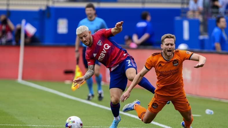 Apr 23, 2022; Frisco, Texas, USA; FC Dallas forward Paul Arriola (7) and Houston Dynamo defender Adam Lundqvist (3) fight for the ball during the first half at Toyota Stadium. Mandatory Credit: Jerome Miron-USA TODAY Sports