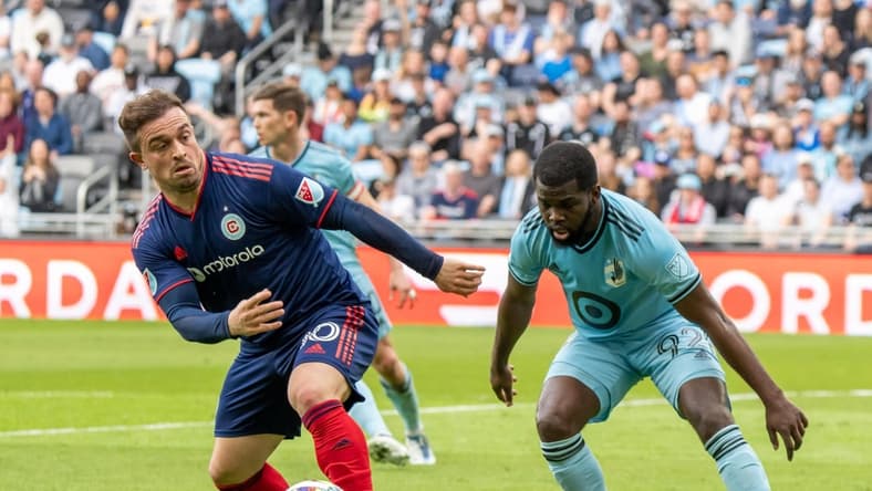 Apr 23, 2022; Saint Paul, Minnesota, USA; Minnesota United defender Kemar Lawrence (92) and Chicago Fire midfielder Xherdan Shaqiri (10) play the ball in the first half at Allianz Field. Mandatory Credit: Matt Blewett-USA TODAY Sports