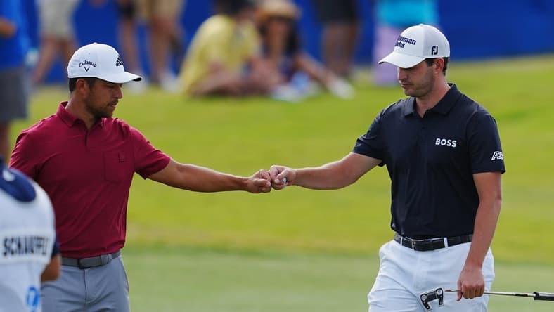 Apr 23, 2022; Avondale, Louisiana, USA; Patrick Cantlay and Xander Schauffele fist bump on the 17th hole during the third round of the Zurich Classic of New Orleans golf tournament. Mandatory Credit: Andrew Wevers-USA TODAY Sports