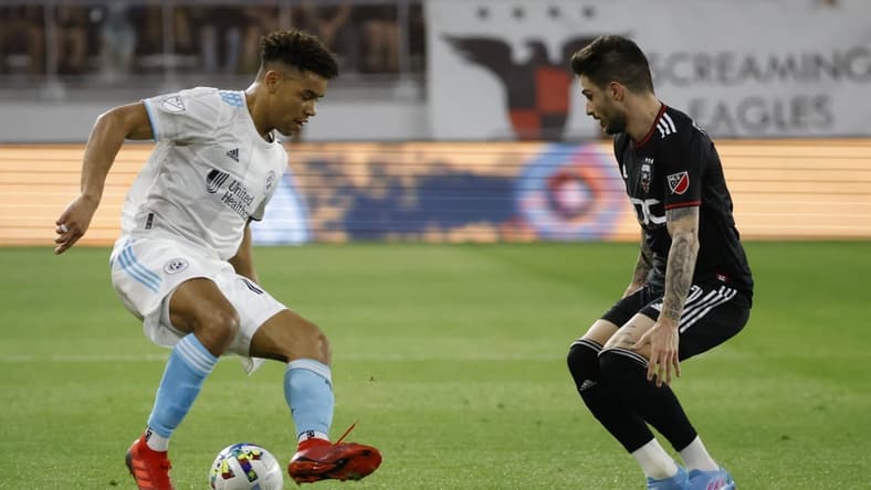 Apr 23, 2022; Washington, District of Columbia, USA; New England Revolution midfielder Brandon Bye (15) dribbles the ball as D.C. United defender Steve Birnbaum (15) defends in the first half at Audi Field. Mandatory Credit: Geoff Burke-USA TODAY Sports
