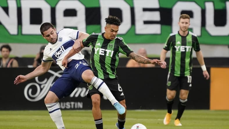 Apr 23, 2022; Austin, Texas, USA; Vancouver Whitecaps forward Brian White (24) and Austin FC midfielder Daniel Pereira (6) battle for the ball in the first half of their match at Q2 Stadium. Mandatory Credit: Scott Wachter-USA TODAY Sports