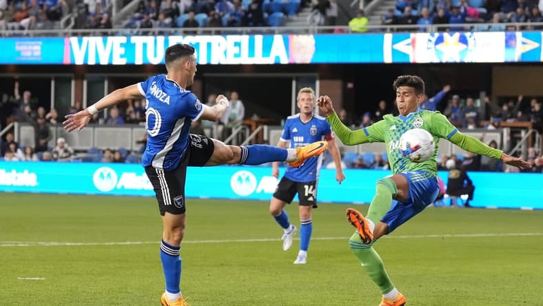 Apr 23, 2022; San Jose, California, USA; San Jose Earthquakes forward Cristian Espinoza (10) scores a goal against Seattle Sounders defender Xavier Arreaga (3) during the first half at PayPal Park. Mandatory Credit: Darren Yamashita-USA TODAY Sports