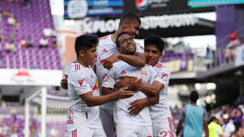 Apr 24, 2022; Orlando, Florida, USA; New York Red Bulls midfielder Cristian Casseres Jr (23) celebrates scoring a goal with teammates in the second half against the Orlando City at Exploria Stadium. Mandatory Credit: Nathan Ray Seebeck-USA TODAY Sports