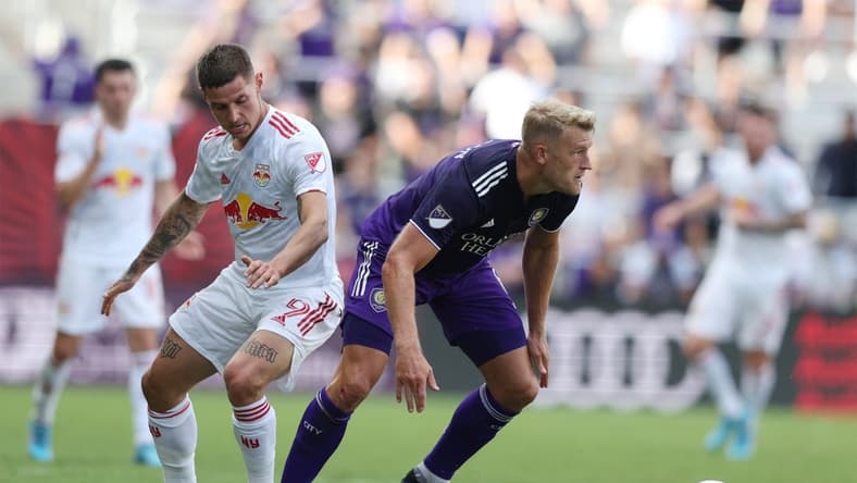 Apr 24, 2022; Orlando, Florida, USA; Orlando City defender Robin Jansson (6) looks to move the ball defended by New York Red Bulls forward Patryk Klimala (9) in the second half at Exploria Stadium. Mandatory Credit: Nathan Ray Seebeck-USA TODAY Sports