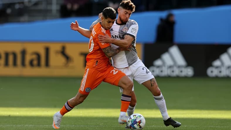 Apr 24, 2022; New York, NY, New York, NY, USA; New York City FC midfielder Santiago Rodriguez (20) and Toronto FC midfielder Jonathan Osorio (21) fight for the ball during the first half at Citi Field. Mandatory Credit: Brad Penner-USA TODAY Sports