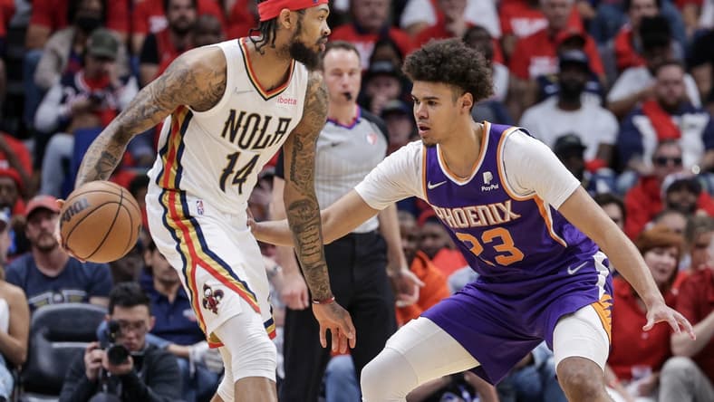 Apr 24, 2022; New Orleans, Louisiana, USA; New Orleans Pelicans forward Brandon Ingram (14) dribbles against Phoenix Suns forward Cameron Johnson (23) during the first half of game four of the first round of the 2022 NBA playoffs at Smoothie King Center. Mandatory Credit: Stephen Lew-USA TODAY Sports