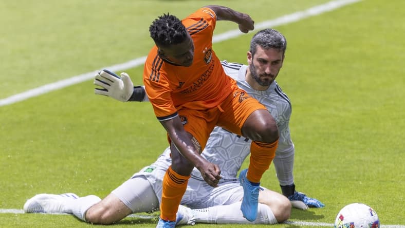 Apr 30, 2022; Houston, Texas, USA; Houston Dynamo FC forward Darwin Quintero (23) dribbles against Austin FC goalkeeper Andrew Tarbell (31) in the first half at PNC Stadium. Mandatory Credit: Thomas Shea-USA TODAY Sports
