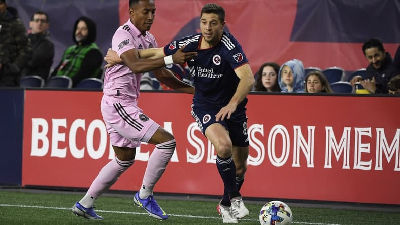 Apr 30, 2022; Foxborough, Massachusetts, USA; Inter Miami defender Jairo Quinteros (15) grabs New England Revolution midfielder Matt Polster (8) during the first half at Gillette Stadium. Mandatory Credit: Bob DeChiara-USA TODAY Sports