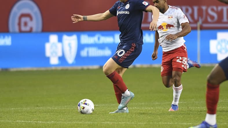 Apr 30, 2022; Chicago, Illinois, USA;  Chicago Fire midfielder Gast  n Gim  nez (30) moves the ball against New York Red Bulls midfielder Cristian C  sseres Jr (23) during the first half at Soldier Field. Mandatory Credit: Matt Marton-USA TODAY Sports