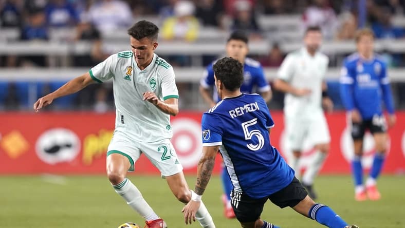 Sep 4, 2021; San Jose, California, USA; Colorado Rapids midfielder Cole Bassett (26) dribbles while being defended by San Jose Earthquakes midfielder Eric Remedi (5) during the first half at PayPal Park. Mandatory Credit: Darren Yamashita-USA TODAY Sports