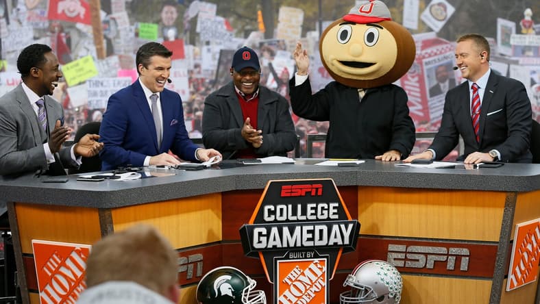Lee Corso waves while wearing a Brutus Buckeye head as, from left, Desmond Howard, Rece Davis, Archie Griffin, and Kirk Herbstreit applaud his pick during ESPN's College GameDay broadcast from the campus of Ohio State prior to the NCAA football game against the Michigan State Spartans in Columbus on Nov. 21, 2015. (Adam Cairns / The Columbus Dispatch)

Osu15msu Ac 07