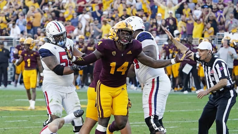 Nov 27, 2021; Tempe, Arizona, USA; Arizona State Sun Devils defensive lineman Stanley Lambert (14) reacts after sacking Arizona Wildcats quarterback Will Plummer (15) during the 95th Territorial Cup game at Sun Devil Stadium. Mandatory Credit: Rob Schumacher-Arizona Republic

Ncaa Football Arizona Wildcats At Arizona State Sun Devils