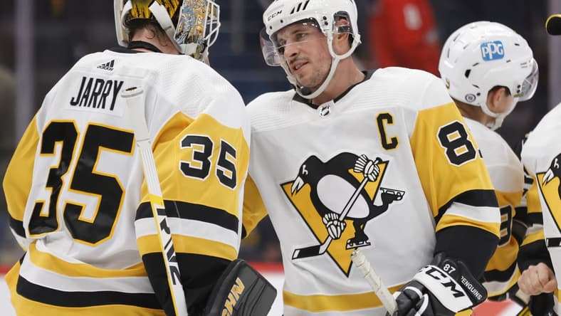 Dec 10, 2021; Washington, District of Columbia, USA; Pittsburgh Penguins goaltender Tristan Jarry (35) celebrates with Penguins center Sidney Crosby (87) after their game against the Washington Capitals at Capital One Arena. Mandatory Credit: Geoff Burke-USA TODAY Sports