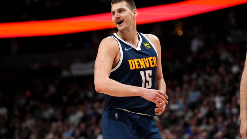 Apr 5, 2022; Denver, Colorado, USA; Denver Nuggets center Nikola Jokic (15) reacts in the second quarter against the San Antonio Spurs at Ball Arena. Mandatory Credit: Ron Chenoy-USA TODAY Sports