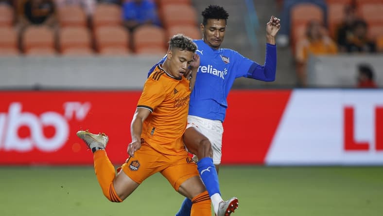 Apr 19, 2022; Houston, Texas, USA; Houston Dynamo FC forward Roberto Avila (45) attempts to kick the ball as Rio Grande Valley FC defender Frank Nodarse (23) defends during the second half at PNC Stadium. Mandatory Credit: Troy Taormina-USA TODAY Sports