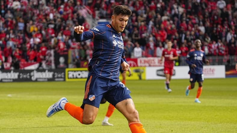 Apr 30, 2022; Toronto, Ontario, CAN; FC Cincinnati forward Brandon Vazquez (19) goes to kick the ball against Toronto FC during the second half at BMO Field. Mandatory Credit: John E. Sokolowski-USA TODAY Sports
