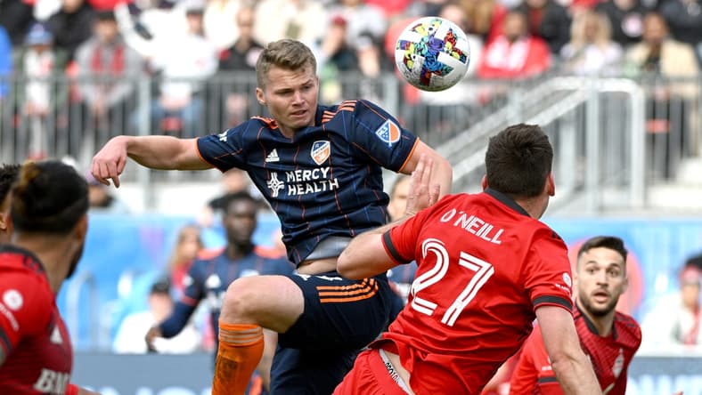 Apr 30, 2022; Toronto, Ontario, CAN; FC Cincinnati midfielder Alvaro Barriel plays a header against Toronto FC in the second half at BMO Field. Mandatory Credit: Dan Hamilton-USA TODAY Sports