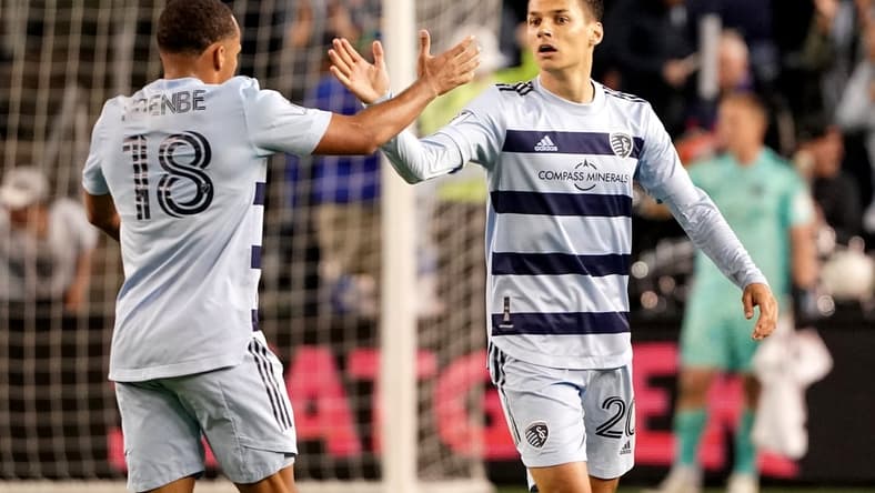 Apr 30, 2022; Kansas City, Kansas, USA; Sporting Kansas City forward Daniel Salloi (20) celebrates with defender Logan Ndenbe (18) after scoring against FC Dallas during the second half at Children's Mercy Park. Mandatory Credit: Denny Medley-USA TODAY Sports