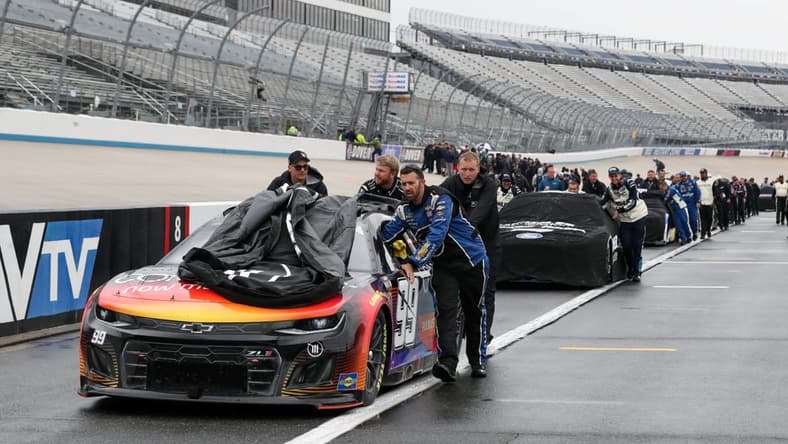 May 1, 2022; Dover, Delaware, USA; NASCAR Cup Series teams push their cars to the garage after the DuraMAX Drydene 400 has been postponed due to weather at Dover Motor Speedway. Mandatory Credit: Matthew OHaren-USA TODAY Sports