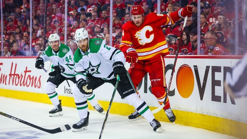 May 3, 2022; Calgary, Alberta, CAN; Dallas Stars defenseman Jani Hakanpaa (2) and Calgary Flames right wing Brett Ritchie (24) battle for the puck during the third period in game one of the first round of the 2022 Stanley Cup Playoffs at Scotiabank Saddledome. Mandatory Credit: Sergei Belski-USA TODAY Sports