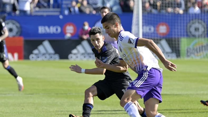 May 7, 2022; Montreal, Quebec, CAN; Orlando City SC defender Joao Moutinho (4) plays the ball and CF Montreal midfielder Joaquin Torres (10) defends during the first half at Stade Saputo. Mandatory Credit: Eric Bolte-USA TODAY Sports