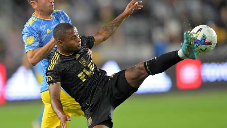 May 7, 2022; Los Angeles, California, USA;  Philadelphia Union midfielder Alejandro Bedoya (11) and Los Angeles FC defender Diego Palacios (12) go for the ball in the first half at Banc of California Stadium. Mandatory Credit: Jayne Kamin-Oncea-USA TODAY Sports