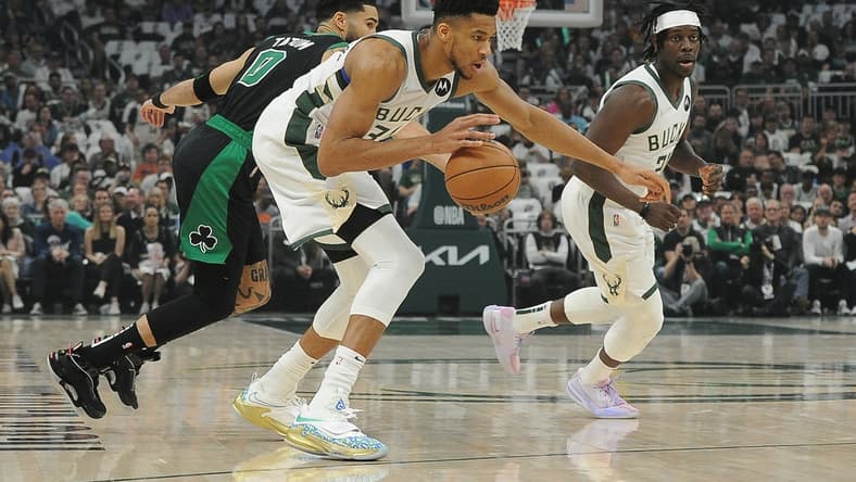 May 9, 2022; Milwaukee, Wisconsin, USA; Milwaukee Bucks forward Giannis Antetokounmpo (34) dribbles the ball against Boston Celtics forward Jayson Tatum (0) in the first half during game four of the second round for the 2022 NBA playoffs at Fiserv Forum. Mandatory Credit: Michael McLoone-USA TODAY Sports