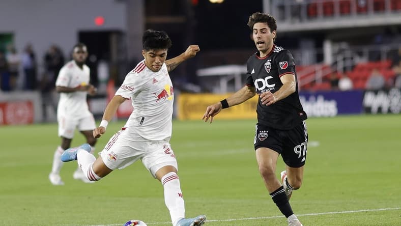 May 10, 2022; Washington, DC, USA; New York Red Bulls midfielder Omir Fernandez (21) shoots the ball as D.C. United midfielder Guediri (97) defends the first half in a US Open Cup match at Audi Field. Mandatory Credit: Geoff Burke-USA TODAY Sports