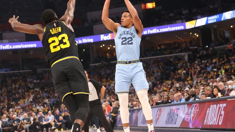 May 11, 2022; Memphis, Tennessee, USA; Memphis Grizzlies guard Desmond Bane (22) shoots the ball over Golden State Warriors forward Draymond Green (23) during game five of the second round for the 2022 NBA playoffs at FedExForum. Mandatory Credit: Joe Rondone-USA TODAY Sports