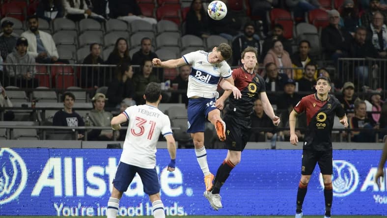 May 11, 2022; Vancouver, British Columbia, Canada;  Vancouver Whitecaps midfielder Sebastian Berhalter (16) goes up for a header against Valour FC forward Daryl Fordyce (16) during the second half at BC Place. Mandatory Credit: Anne-Marie Sorvin-USA TODAY Sports