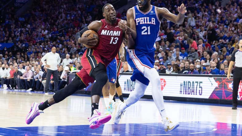 May 12, 2022; Philadelphia, Pennsylvania, USA; Miami Heat center Bam Adebayo (13) drives against Philadelphia 76ers center Joel Embiid (21) during the first quarter in game six of the second round of the 2022 NBA playoffs at Wells Fargo Center. Mandatory Credit: Bill Streicher-USA TODAY Sports