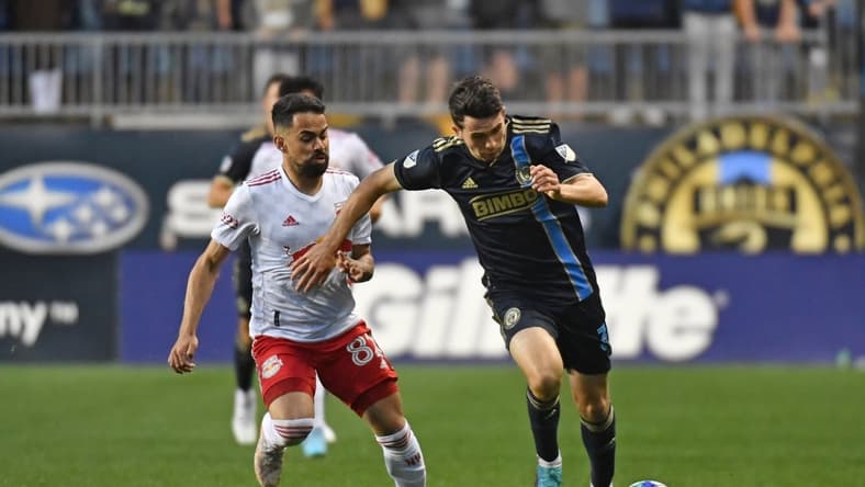 May 14, 2022; Philadelphia, Pennsylvania, USA; Philadelphia Union midfielder Leon Flach (31) pushes the ball upfield against New York Red Bulls midfielder Luquinhas (82) during the first half at Subaru Park. Mandatory Credit: Eric Hartline-USA TODAY Sports