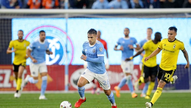 May 14, 2022; New York, New York, USA; New York City FC midfielder Nicolas Acevedo (26) brings the ball up the pitch against Columbus Crew midfielder Lucas Zelarrayan (10) during the first half at Yankee Stadium. Mandatory Credit: Brad Penner-USA TODAY Sports