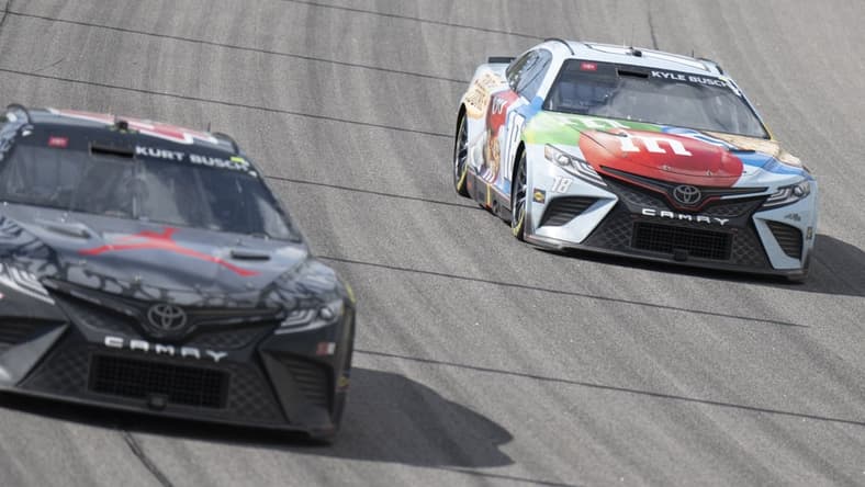 May 15, 2022; Kansas City, Kansas, USA; NASCAR Cup Series driver Kurt Busch (45) and NASCAR Cup Series driver Kyle Busch (18) race during the AdventHealth 400 at Kansas Speedway. Mandatory Credit: Amy Kontras-USA TODAY Sports