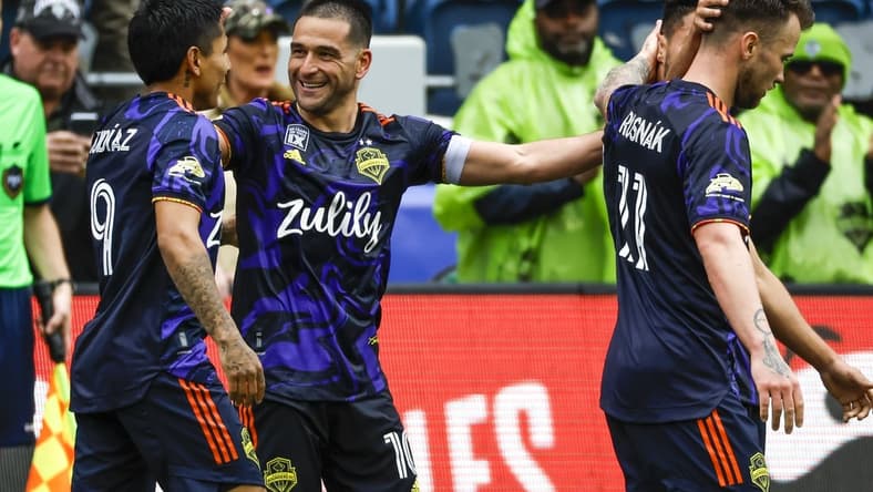May 15, 2022; Seattle, Washington, USA; Seattle Sounders FC midfielder Nicolas Lodeiro (10) celebrates with forward Raul Ruidiaz (9)) after scoring a goal against the Minnesota United FC during the second half at Lumen Field. Mandatory Credit: Joe Nicholson-USA TODAY Sports