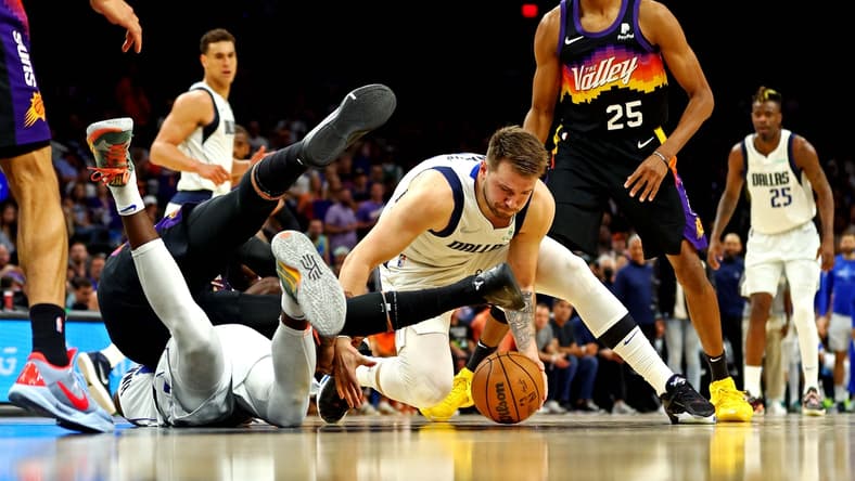 May 15, 2022; Phoenix, Arizona, USA; Dallas Mavericks guard Luka Doncic (77) goes for a ball against Phoenix Suns forward Mikal Bridges (25) during the second quarter in game seven of the second round for the 2022 NBA playoffs at Footprint Center. Mandatory Credit: Mark J. Rebilas-USA TODAY Sports