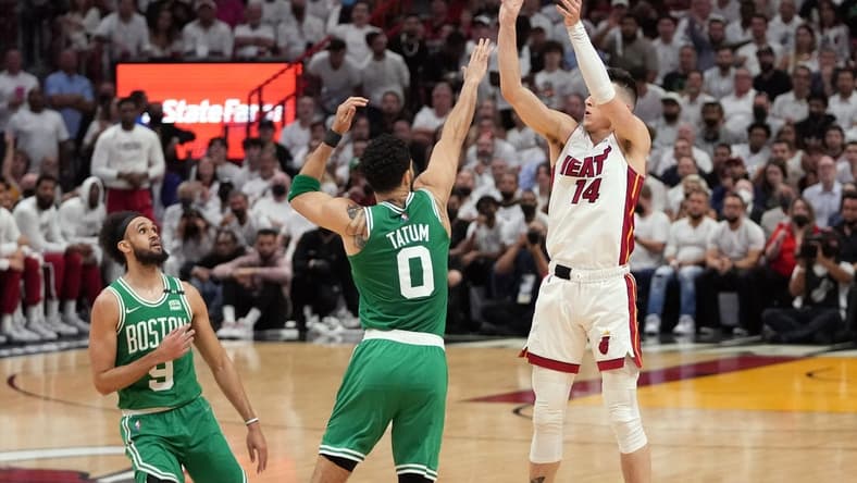 May 17, 2022; Miami, Florida, USA; Miami Heat guard Tyler Herro (14) takes a shot over Boston Celtics forward Jayson Tatum (0) during the first half of game one of the 2022 eastern conference finals at FTX Arena. Mandatory Credit: Jasen Vinlove-USA TODAY Sports