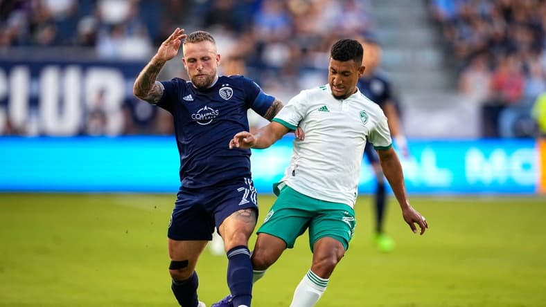May 18, 2022; Kansas City, Kansas, USA; Sporting Kansas City forward Johnny Russell (7) and Colorado Rapids midfielder Bryan Acosta (21) fight for the ball during the first half at Children's Mercy Park. Mandatory Credit: Jay Biggerstaff-USA TODAY Sports