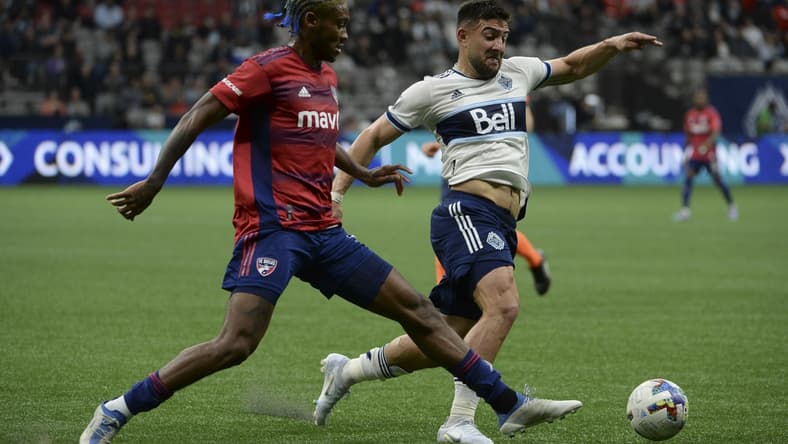 May 18, 2022; Vancouver, British Columbia, CAN;  Vancouver Whitecaps forward Lucas Cavallini (9) reaches for the ball against FC Dallas defender Nkosi Tafari (17) during the first half at BC Place. Mandatory Credit: Anne-Marie Sorvin-USA TODAY Sports