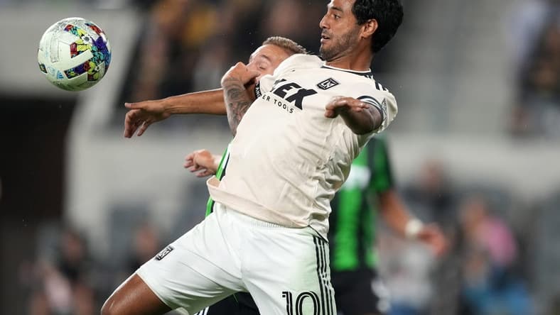 May 18, 2022; Los Angeles, California, USA; LAFC forward Carlos Vela (10) and Austin FC defender   an Kolmani   (23) battle for the ball in the second half at Banc of California Stadium. Mandatory Credit: Kirby Lee-USA TODAY Sports